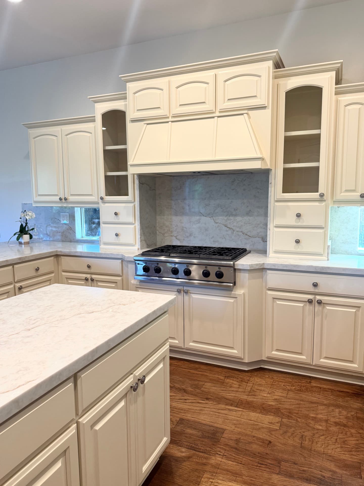 Tiled kitchen backsplash with stacked rectangular pattern between white cabinets and quartz countertop in an El Dorado Hills remodel