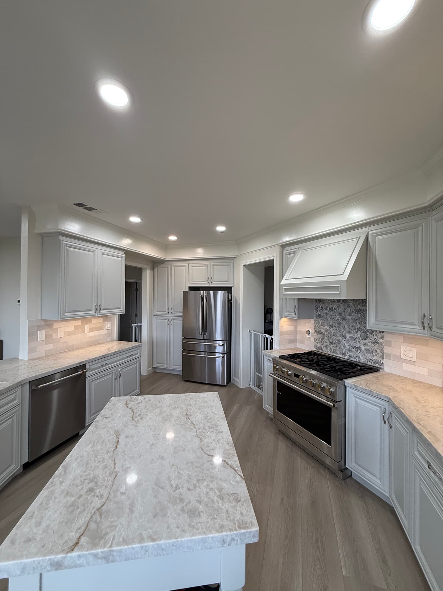 Polished white quartz kitchen countertop with subtle veining wrapping a Granite Bay island and perimeter cabinets