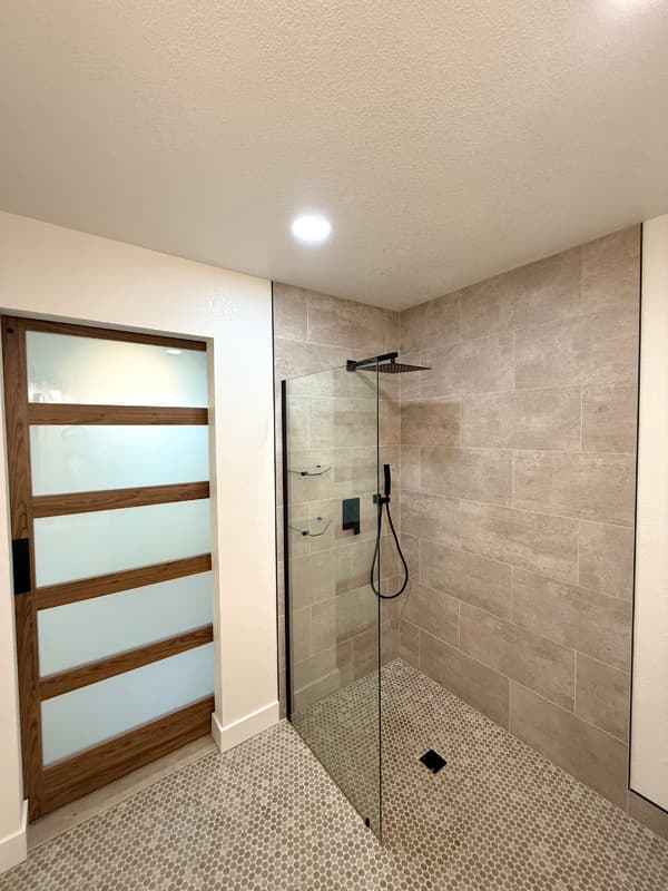 Garage ADU conversion — walk-in shower with penny tile floor — gallery thumbnail 11